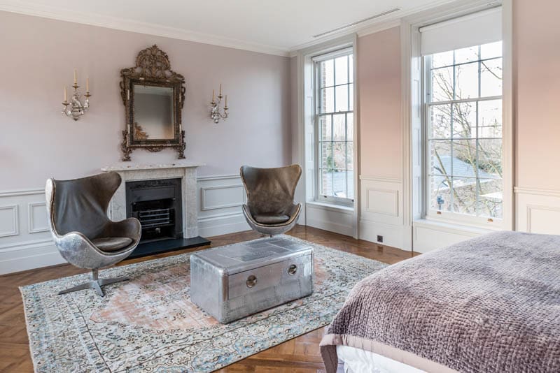 One of the many guest bedrooms at Templeton House in London with the large sash windows made by Gowercroft Joinery using vacuum glazing by LandVac supplied by Vacuum Glazing UK