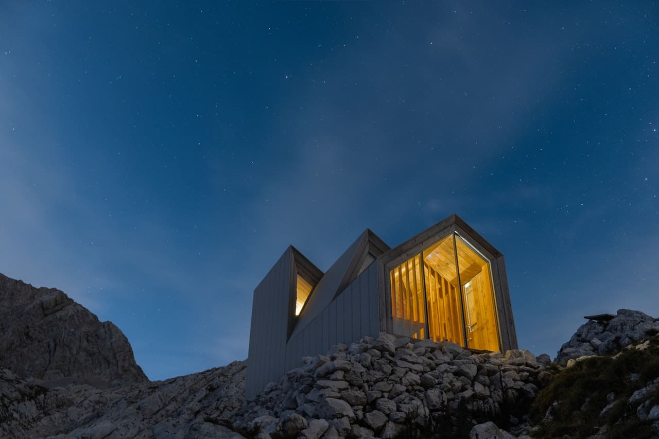 Night time show of futuristic building on rocks to illustrate the effectiveness of vacuum glazing