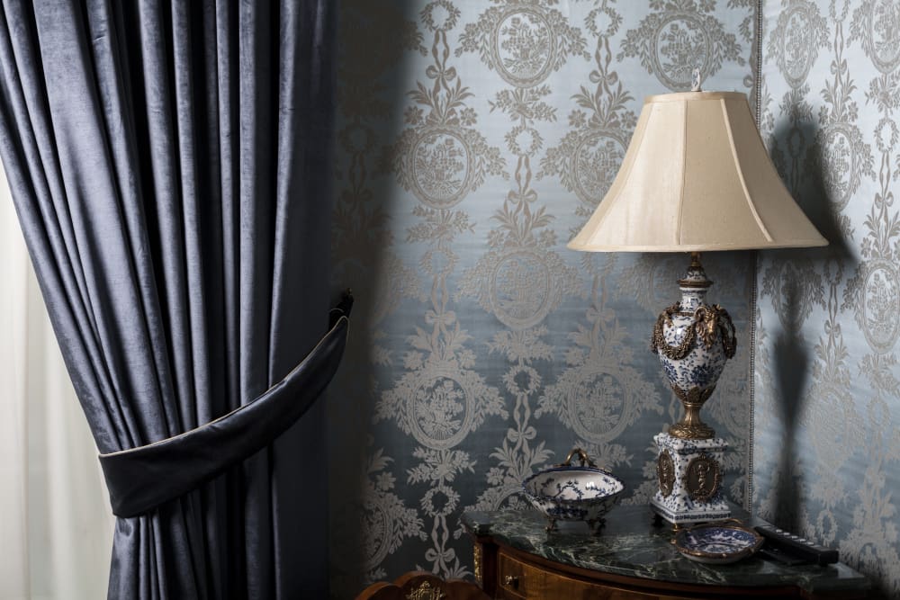 Heavy curtains in a traditionally furnished room
