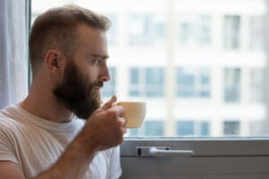 What are the most energy efficient windows - a hipster drinking coffee and looking pensive next to an energy efficient window