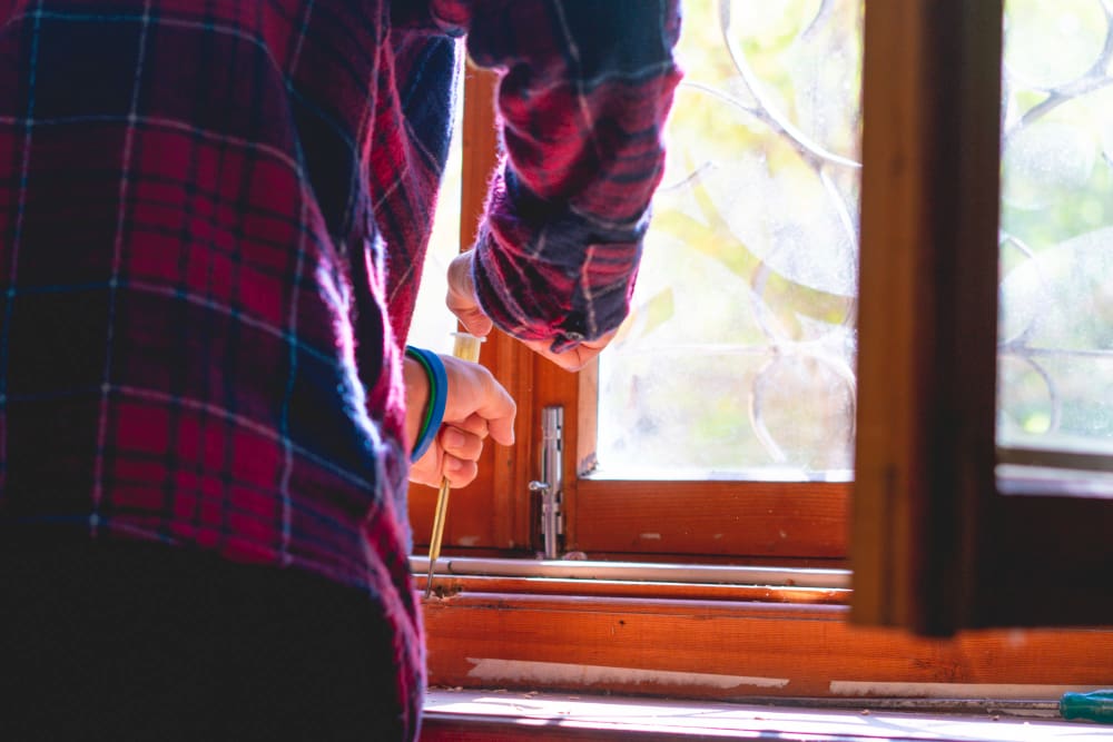 Timber window renovator repairing a window