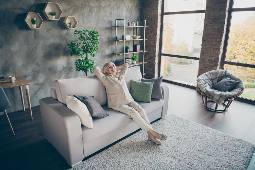 How can I soundproof my home - senior lady relaxing in a soundproof living room