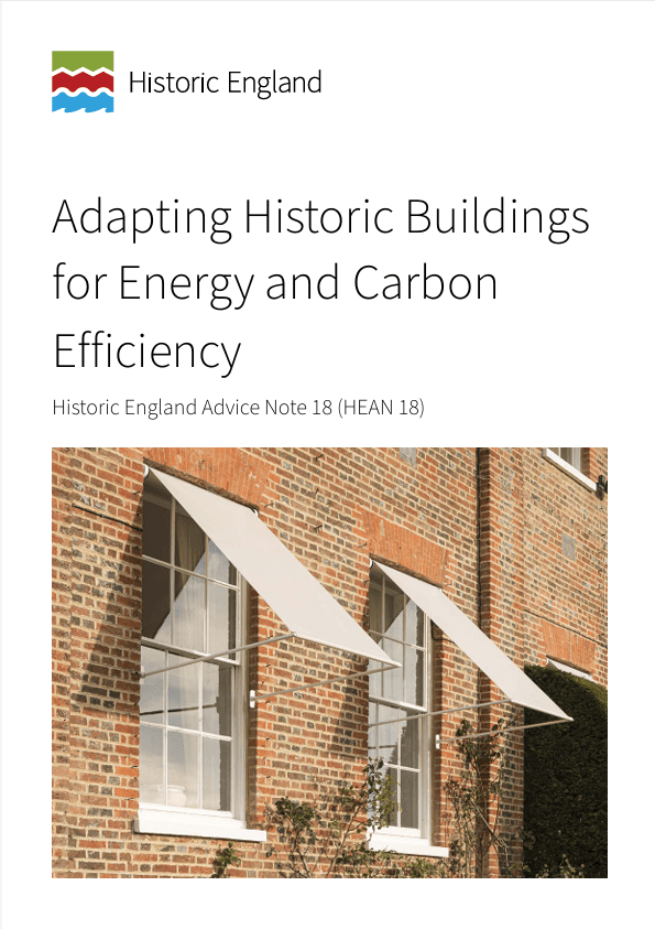 Cover of Historic England’s Advice Note 18 titled “Adapting Historic Buildings for Energy and Carbon Efficiency”, featuring two traditional sash windows on a red-brick façade shaded by pale awnings.